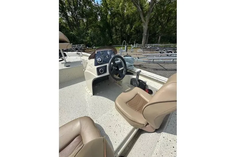 Slide: The Image of 2020 Xpress XP170 boat interior with steering wheel and beige seats. - 11