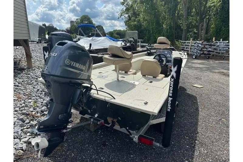 Slide: The Image of 2020 Xpress XP170 boat with Yamaha motor, parked outdoors on gravel. - 4