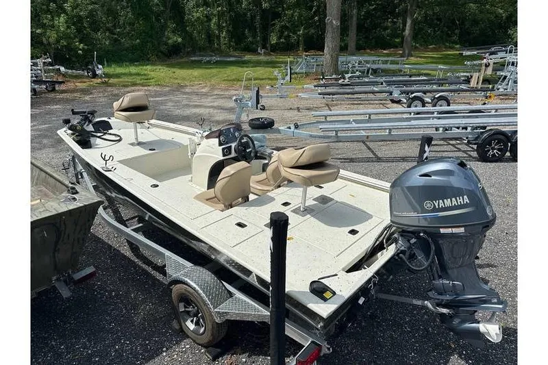 Slide: The Image of 2020 Xpress XP170 boat with Yamaha motor on trailer, parked outdoors. - 6