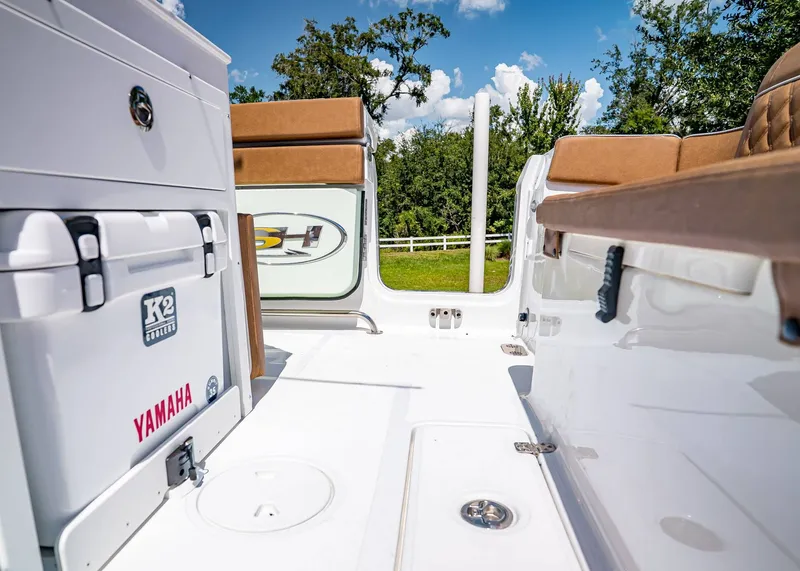 Slide: The Image of 2026 Sea Hunt Ultra 275 SE boat interior with Yamaha cooler, brown seating, and sunny outdoor view. - 10