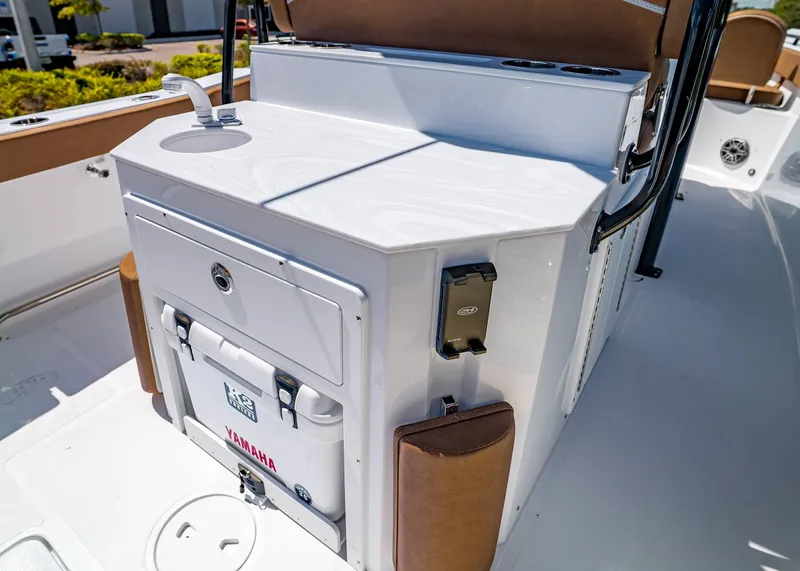 Slide: The Image of 2026 Sea Hunt Ultra 275 SE boat interior with sink and storage compartment. - 14