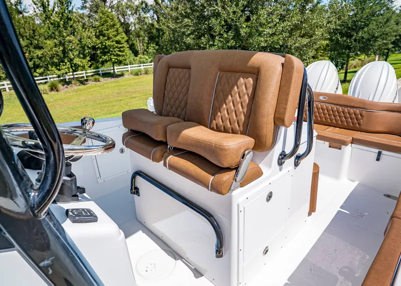 Slide: The Image of 2026 Sea Hunt Ultra 275 SE boat interior with luxurious brown seating and steering wheel. - 17
