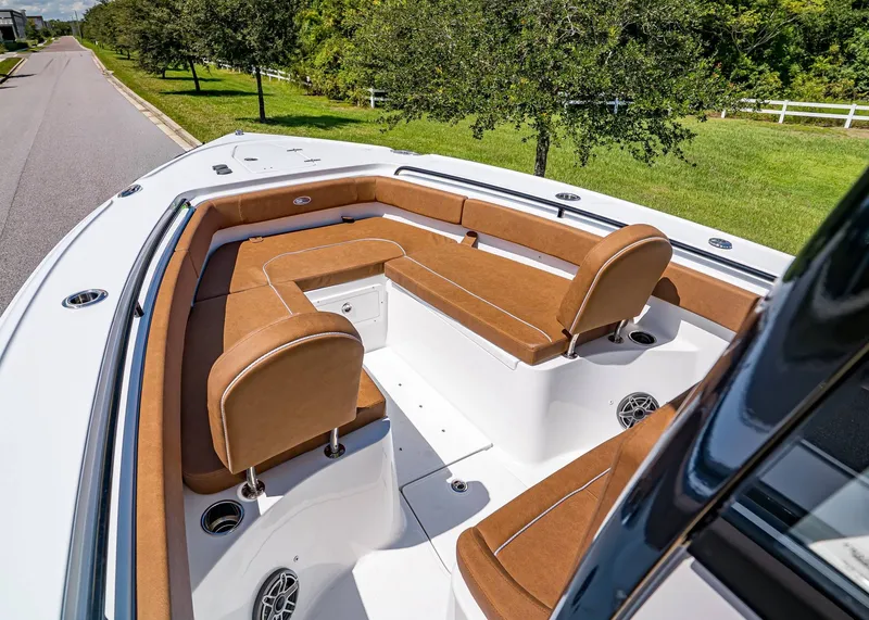 Slide: The Image of 2026 Sea Hunt Ultra 275 SE boat with brown seating and spacious deck design. - 24