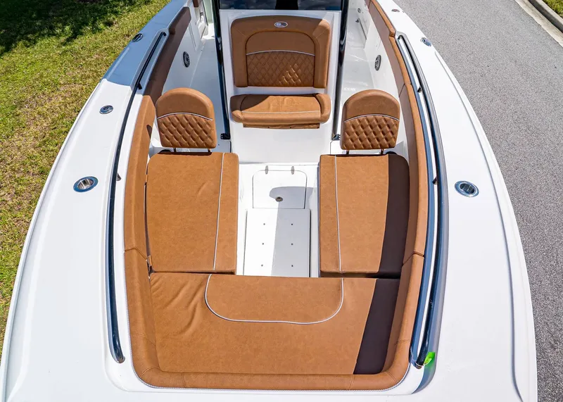 Slide: The Image of 2026 Sea Hunt Ultra 275 SE boat with luxurious brown seating and spacious deck layout. - 23