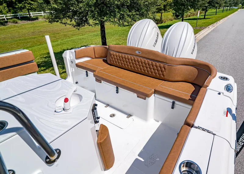 Slide: The Image of 2026 Sea Hunt Ultra 275 SE boat interior with brown seating and dual Yamaha engines. - 8