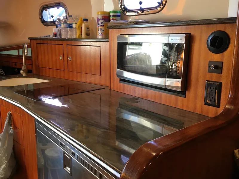 Slide: The Image of 2013 Pursuit OS 385 Offshore boat helm with dual screens and steering wheel. - 11