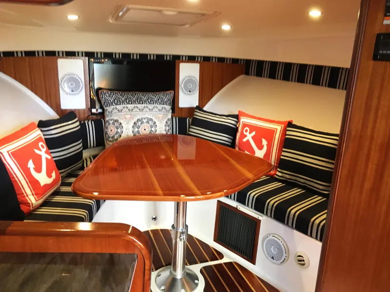 Slide: The Image of Captain's chair on a 2013 Pursuit OS 385 Offshore boat. - 12