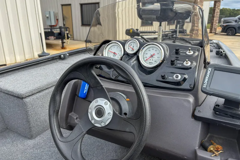 Slide: The Image of 2023 Tracker Pro 170 boat dashboard with steering wheel and gauges. - 4