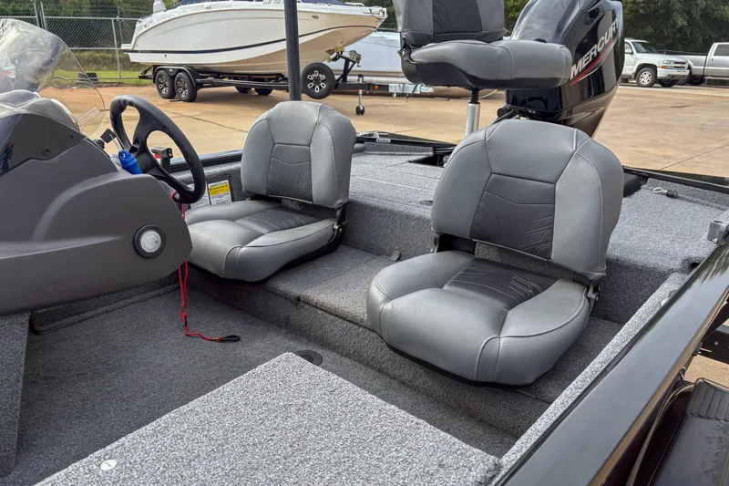 Slide: The Image of 2023 Tracker Pro 170 boat interior with gray seats and steering wheel. - 9
