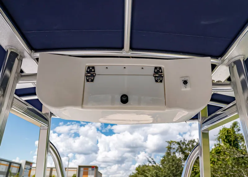 Slide: The Image of 2026 Sea Hunt Ultra 219 boat canopy with storage compartment and light switch. - 12