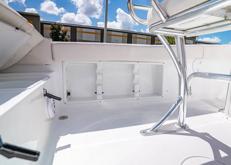 Slide: The Image of 2026 Sea Hunt Ultra 219 boat interior with storage compartment and stainless steel fixtures. - 14