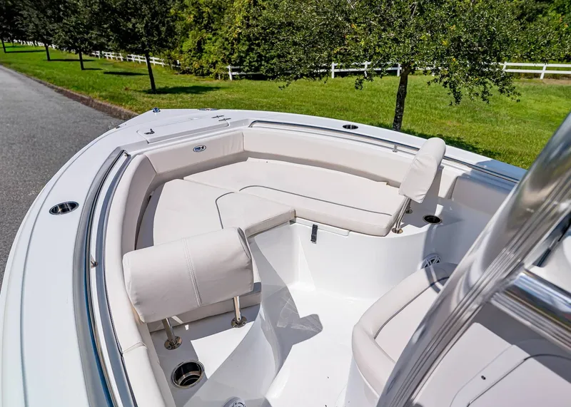 Slide: The Image of 2026 Sea Hunt Ultra 219 boat interior with white seating and cup holders. - 17