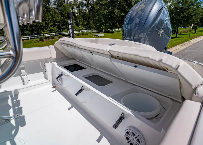 Slide: The Image of 2026 Sea Hunt Ultra 219 boat interior with open storage compartments and Yamaha engine. - 8