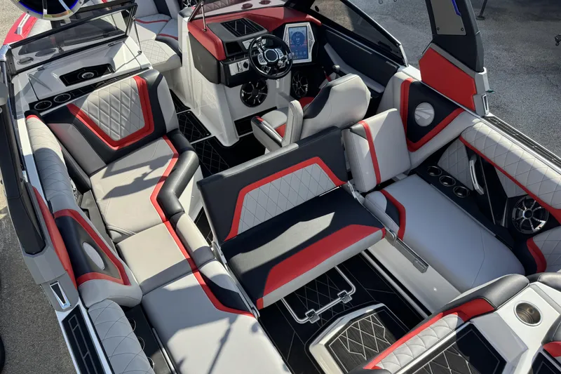 Slide: The Image of 2019 Tigé ZX1 boat interior with red and gray upholstery, featuring modern dashboard and seating. - 8