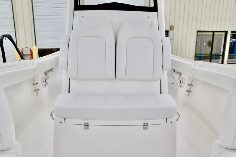 Slide: The Image of 2026 Regulator 25 boat interior with white cushioned seating. - 13