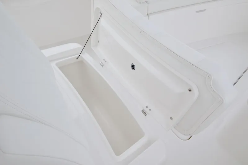 Slide: The Image of 2026 Regulator 25 boat storage compartment with open lid, showcasing spacious interior. - 14