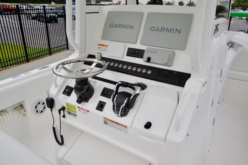 Slide: The Image of 2026 Regulator 25 boat console with dual Garmin displays and steering wheel. - 15