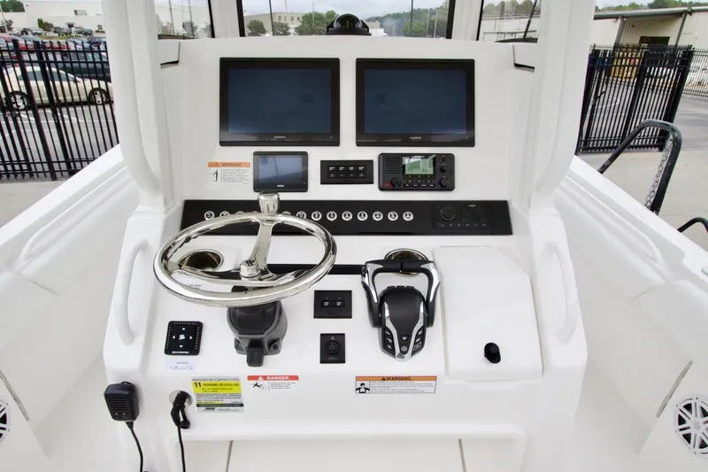 Slide: The Image of 2026 Regulator 25 boat dashboard with dual screens and modern controls. - 16