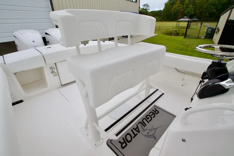 Slide: The Image of 2026 Regulator 25 boat interior with white seating and steering wheel. - 19