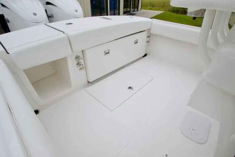 Slide: The Image of 2026 Regulator 25 boat interior with storage compartments and sleek white design. - 20