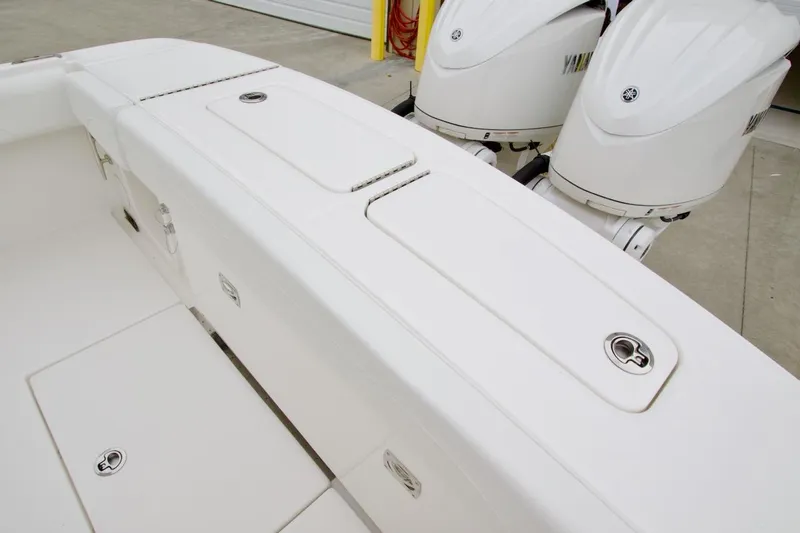 Slide: The Image of 2026 Regulator 25 boat with dual outboard engines and sleek white deck design. - 21