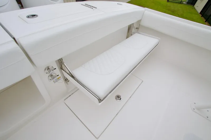 Slide: The Image of 2026 Regulator 25 boat with white fold-down seat and sleek design. - 23