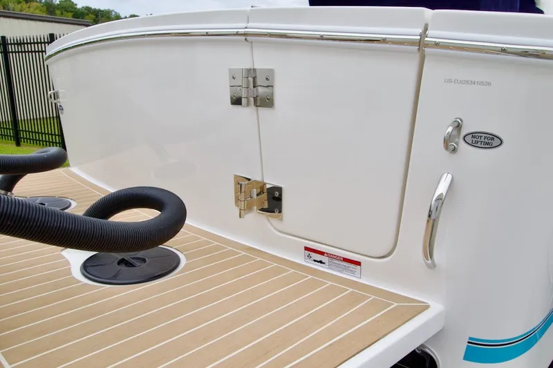 Slide: The Image of 2026 Regulator 25 boat stern with teak deck and stainless steel fittings. - 6