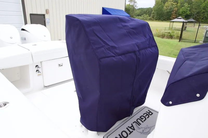 Slide: The Image of 2026 Regulator 25 boat with blue protective covers on seats and console. - 7