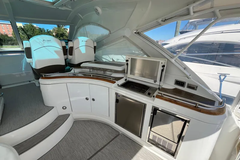 Slide: The Image of Interior of 2010 Cruisers Yachts 520 Sports Coupe with helm and seating area. - 10