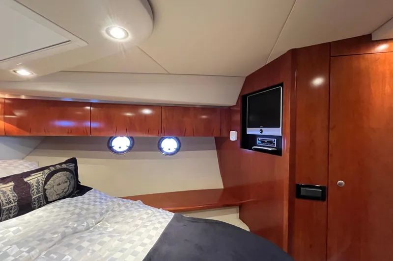 Slide: The Image of Luxurious cabin interior of 2010 Cruisers Yachts 520 Sports Coupe with wood finish and portholes. - 20