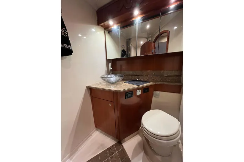 Slide: The Image of Luxurious bathroom in 2010 Cruisers Yachts 520 Sports Coupe with elegant fixtures and wood accents. - 22