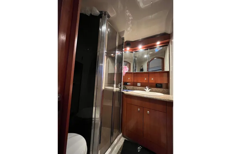 Slide: The Image of Luxurious bathroom in 2010 Cruisers Yachts 520 Sports Coupe with wood cabinetry and glass shower. - 26