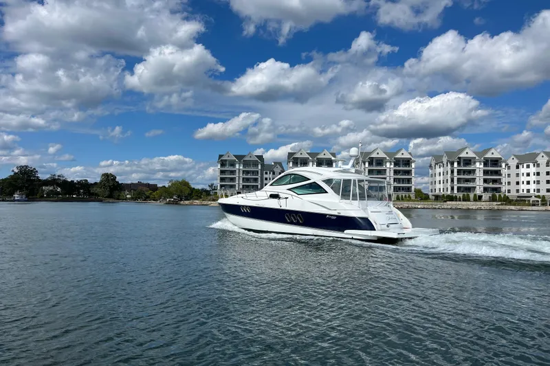 Slide: The Image of 2010 Cruisers Yachts 520 Sports Coupe docked at marina under clear blue sky. - 9