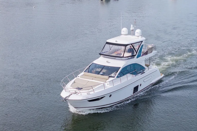 Slide: The Image of Luxury 2020 Azimut Fly 50 yacht cruising on calm waters. - 16