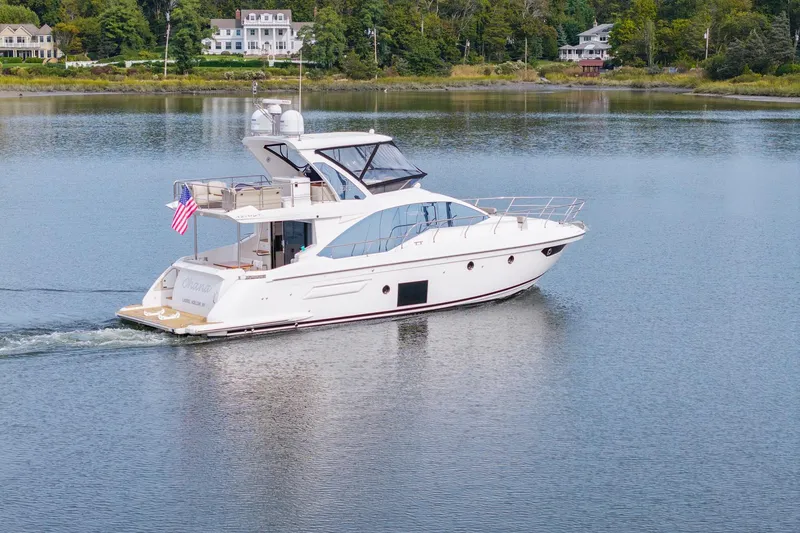 Slide: The Image of Azimut Fly 50 yacht cruising on a serene lake, surrounded by lush greenery. - 2