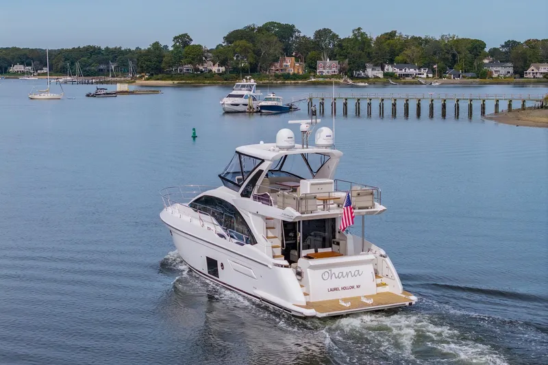 Slide: The Image of Azimut Fly 50 yacht cruising in a serene harbor, 2020 model. - 22