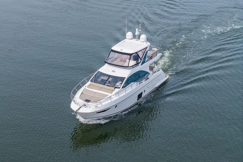 Slide: The Image of 2020 Azimut Fly 50 yacht cruising on calm waters, aerial view. - 25