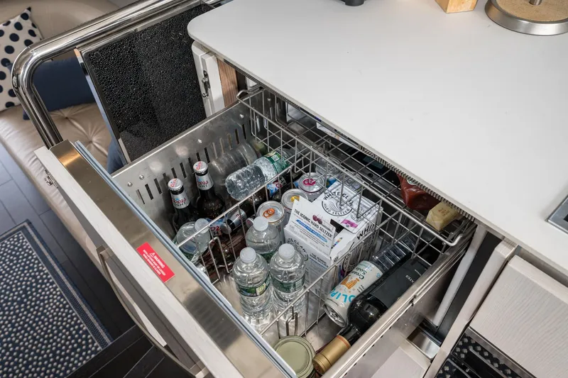 Slide: The Image of Beverage drawer on 2020 Azimut Fly 50 yacht, stocked with drinks and water bottles. - 32