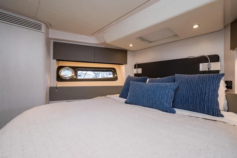 Slide: The Image of Luxurious bedroom interior of 2020 Azimut Fly 50 yacht with modern design and blue pillows. - 43