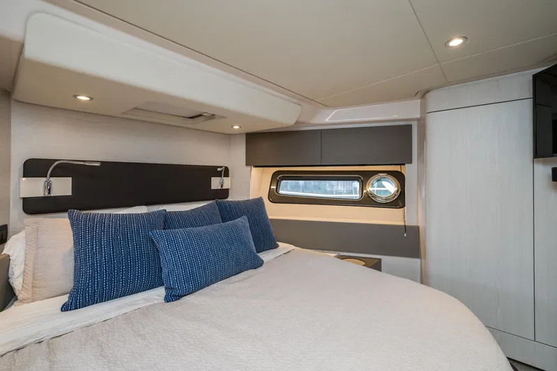 Slide: The Image of Luxurious bedroom interior of 2020 Azimut Fly 50 yacht with modern design and blue accents. - 44