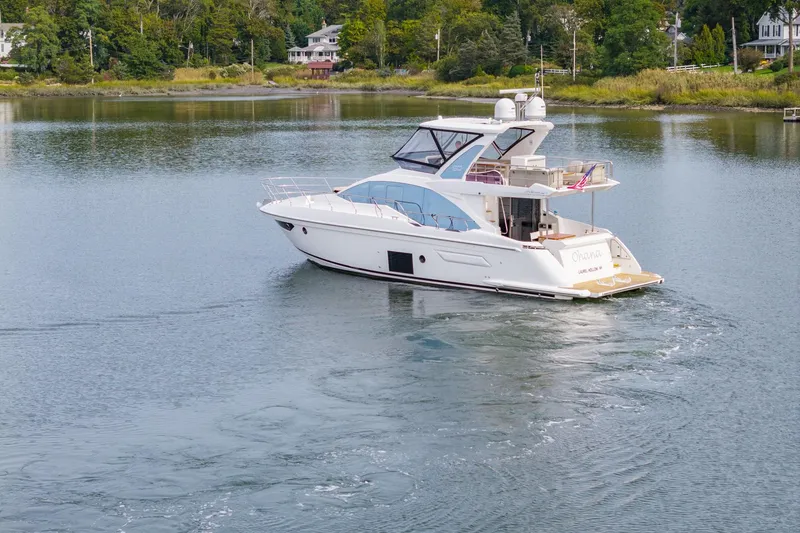 Slide: The Image of Azimut Fly 50 yacht cruising on a serene lake, surrounded by lush greenery. - 5