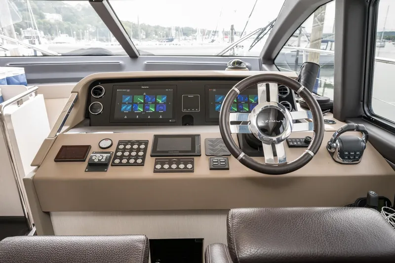 Slide: The Image of Cockpit of 2020 Azimut Fly 50 yacht with modern navigation controls and leather steering wheel. - 51