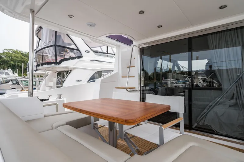 Slide: The Image of Luxurious 2020 Azimut Fly 50 yacht with elegant outdoor seating and wooden table. - 64
