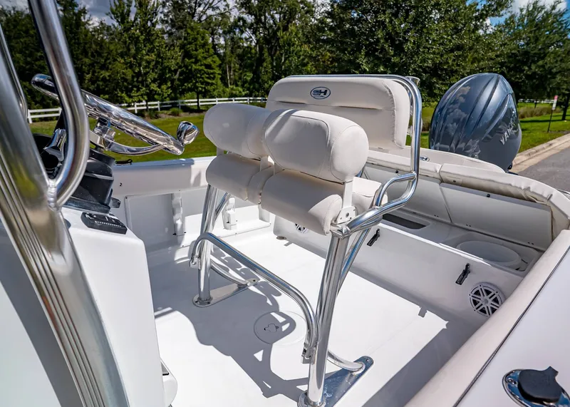 Slide: The Image of 2026 Sea Hunt Ultra 219 boat interior with white seating and steering wheel. - 11