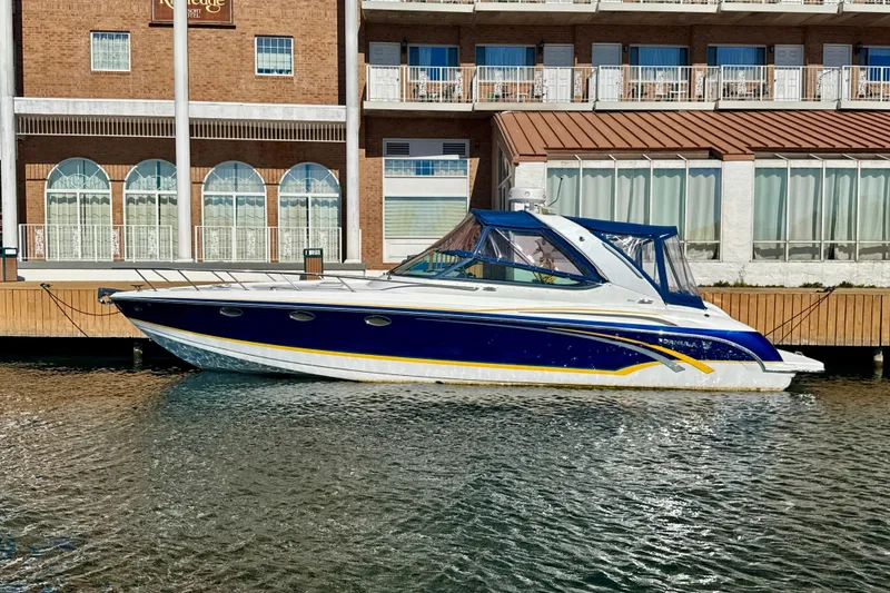 Slide: The Image of 2006 Formula 370 Super Sport boat docked by a waterfront building. - 0