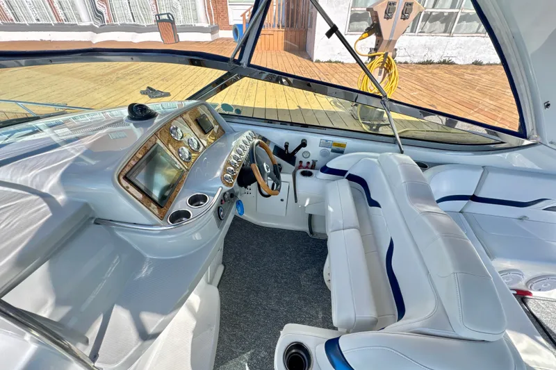 Slide: The Image of 2006 Formula 370 Super Sport boat cockpit with sleek dashboard and white seating. - 10