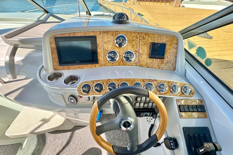 Slide: The Image of Dashboard of a 2006 Formula 370 Super Sport boat with steering wheel and gauges. - 11