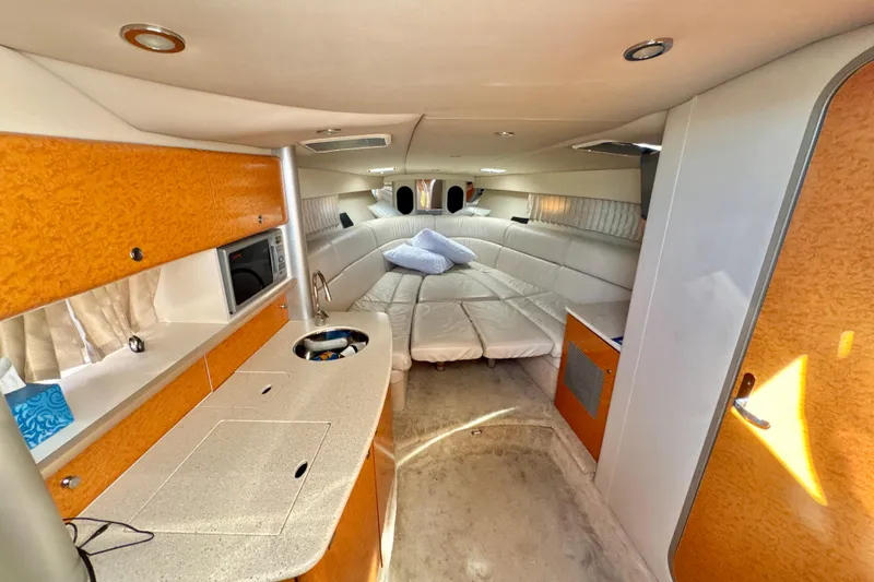 Slide: The Image of Interior of a 2006 Formula 370 Super Sport boat with modern amenities and cozy seating. - 13