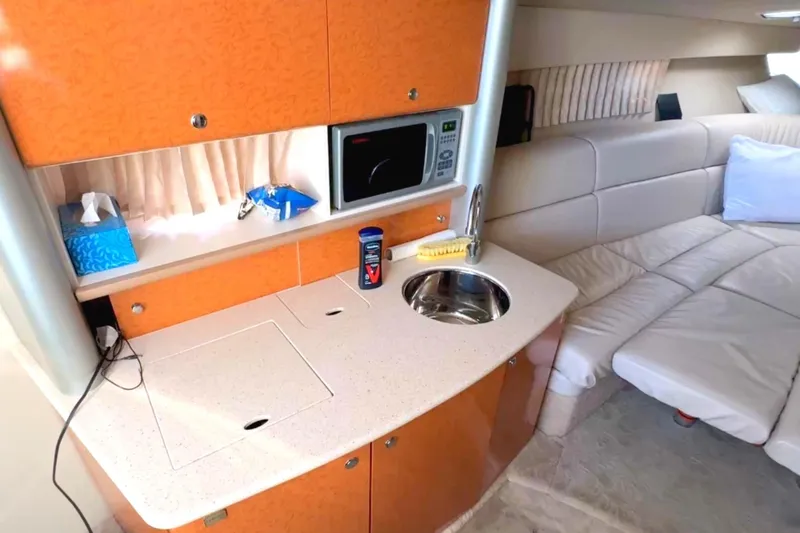 Slide: The Image of 2006 Formula 370 Super Sport interior with kitchenette, sink, microwave, and seating area. - 14