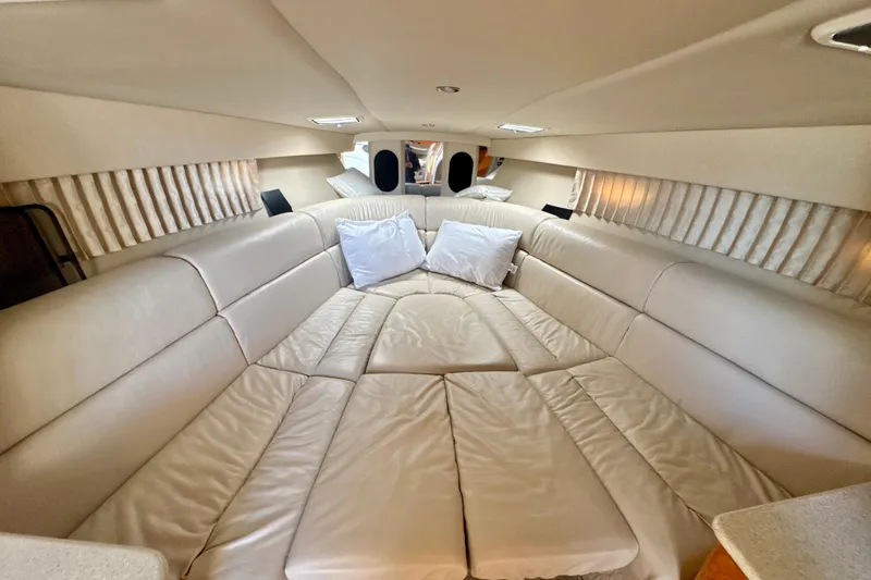 Slide: The Image of Interior cabin of 2006 Formula 370 Super Sport with plush beige seating and pillows. - 15